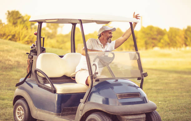 istock Senior man driving golf car. 1313423018