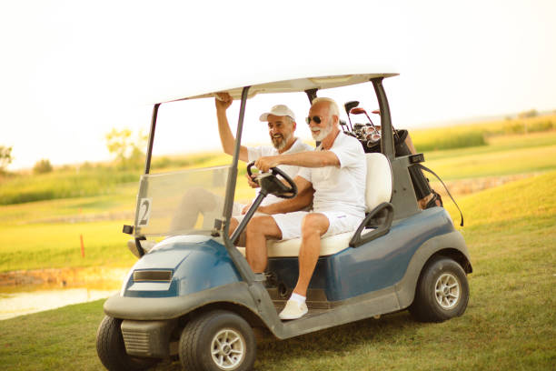 istock Two older friends are riding in a golf cart. 1313423980
