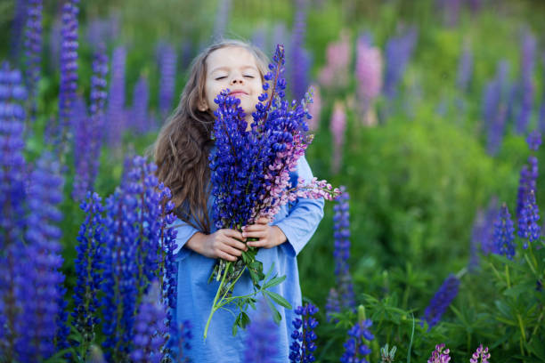 istock a child sniffs a bouquet of wildflowers 1313424065