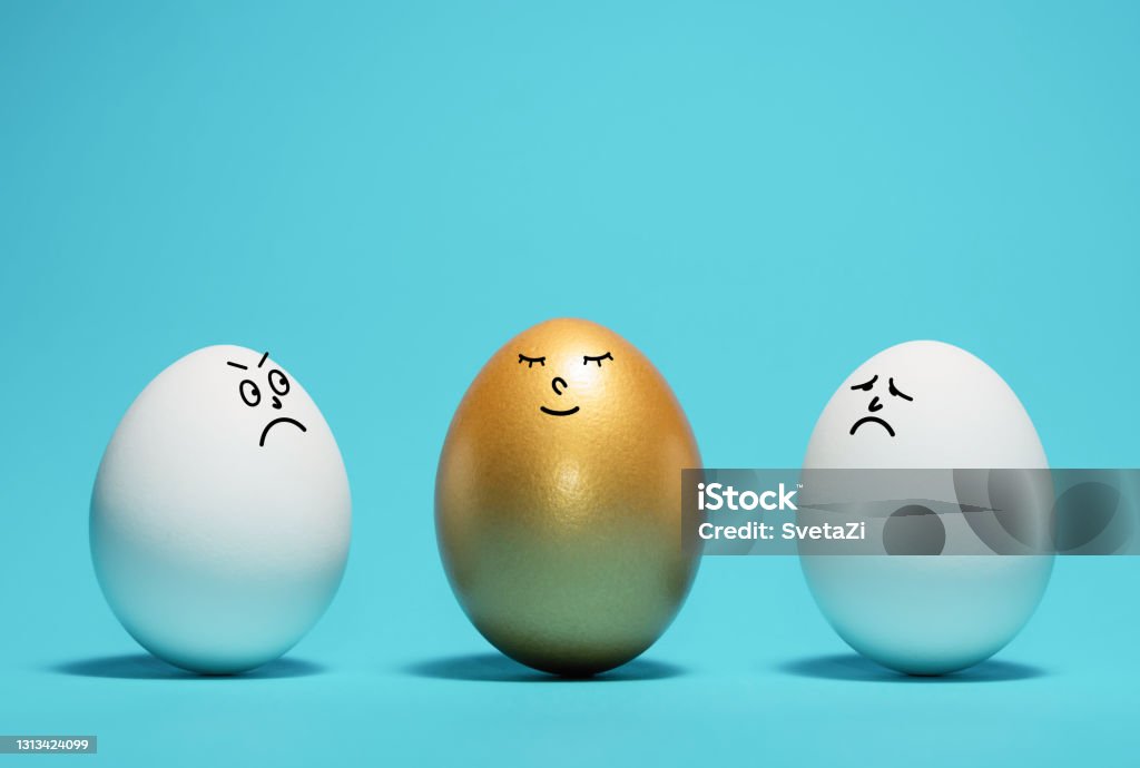 Concept of exclusivity, best choice, hiring. Golden egg with a funny smiling face among the white eggs. Concept of exclusivity, best choice, hiring. Anthropomorphic Face Stock Photo Concept of exclusivity, best choice, hiring. Golden egg with a funny smiling face among the white eggs. Concept of exclusivity, best choice, hiring. Anthropomorphic Face Stock Photo