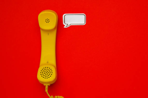 istock Yellow telephone speaker and speech bubble on red background 1313424302