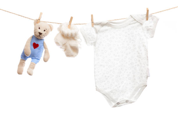 istock Baby clothes on a clothesline on white  background - Image 1313427090