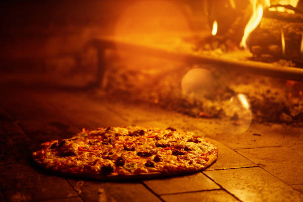 Delicious pizza baking in a wood fire oven