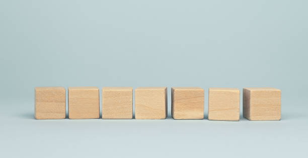 istock Seven blank wooden cube blocks on blue background 1313428954