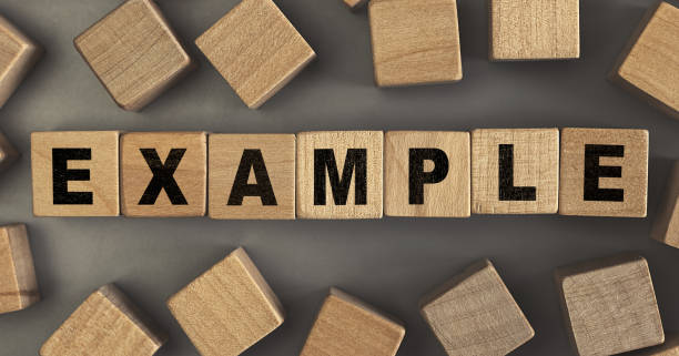 istock The word EXAMPLE on small wooden blocks at the desk. Top view 1313428979