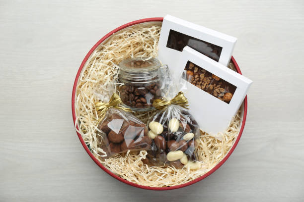 istock Gift box with chocolate and sweets on white wooden table, top view 1313430158
