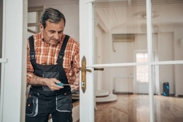 istock Carpenter repairing the door 1313431706