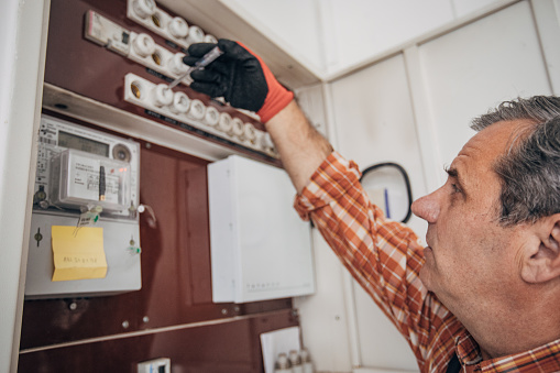 An electrician controls the home installation