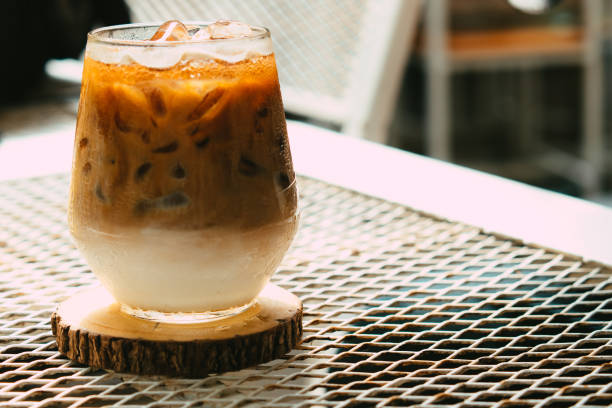 istock Iced latte coffee in a glass with cream on bottom 1313434427