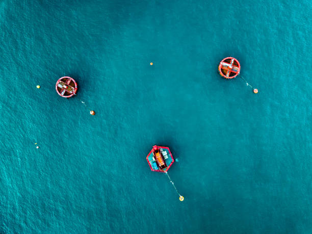 Aerial view of Blue Sea surface with buoys Aerial view of Blue Sea surface with red buoys buoy stock pictures, royalty-free photos & images