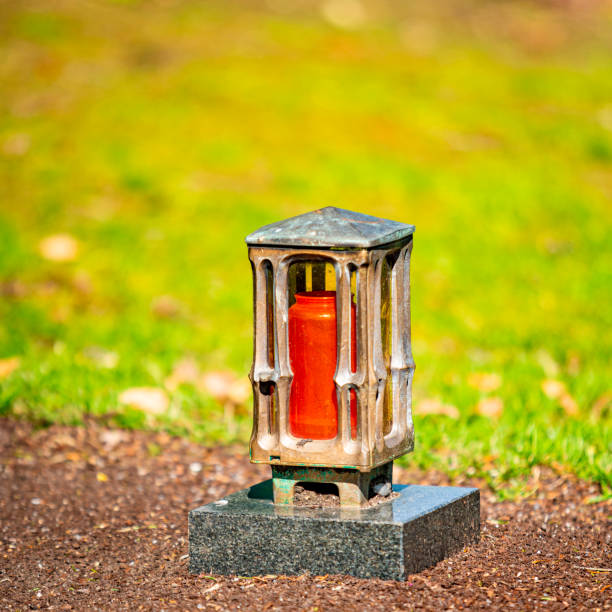 istock Grave light with  candle on a grave with flowers 1313434759