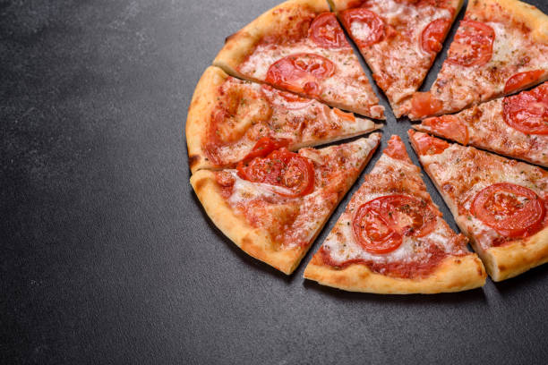 istock Tasty fresh oven pizza with tomatoes, cheese and basil on a concrete background 1313434811