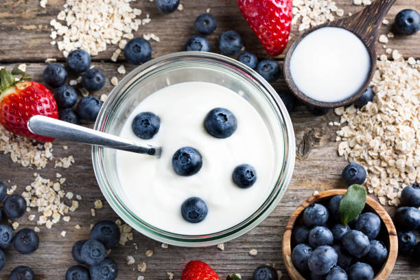 istock Strawberries, blueberries, oat flakes and yoghurt - top view 1313435966