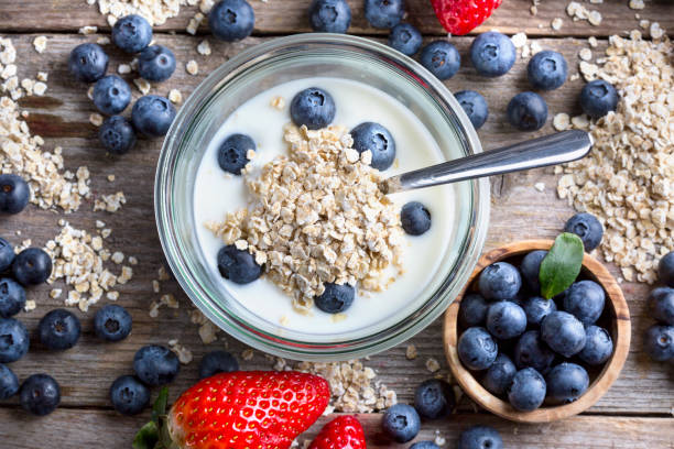 istock Strawberries, blueberries, oat flakes and yoghurt - top view 1313435995