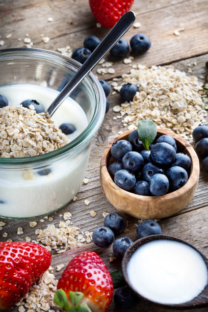 istock Strawberries, blueberries, oat flakes and yoghurt - top view 1313436009