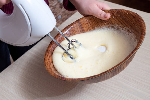 Whipping eggs with sugar in a bowl. Selective focus. Whipping eggs with sugar in a bowl. Selective focus. electric whisk stock pictures, royalty-free photos & images