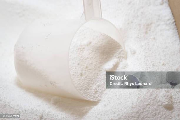 A Scoop Measures Out Laundry Detergent Powder For Washing Machine Use Stock Photo - Download Image Now