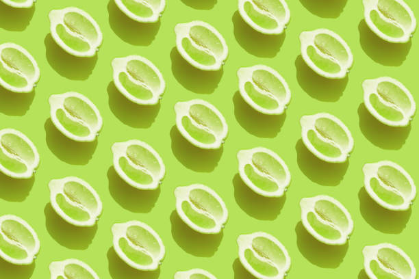 istock Pattern with halves of lemon with shadow on green background 1313439218