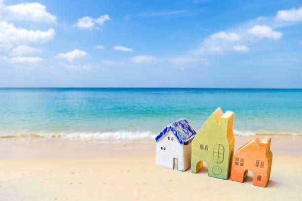 istock Colorful miniature house on the beach 1313439506