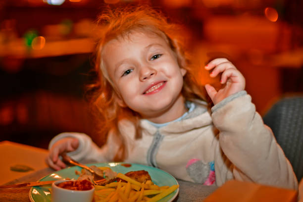 Girl having dinner in a restaurant.