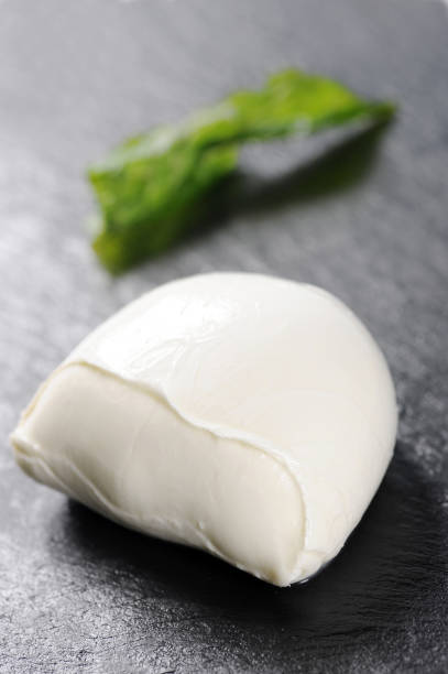 istock buffalo mozzarella and fried basil made by a chef with a very elegant design on black dish 1313441404