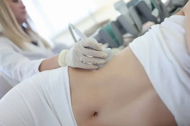 Doctor conducts ultrasound examination of patientv kidneys. Internal organs ultrasound concept