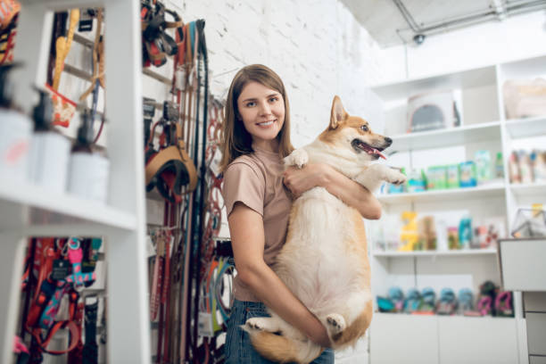 A happy girl and her cute dog in a pet store Pet shop. A happy girl and her cute dog in a pet store pet shop photos stock pictures, royalty-free photos & images