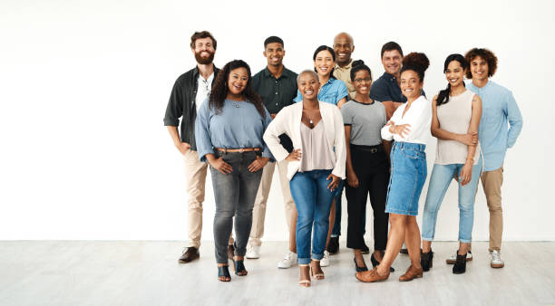 Full length portrait of a diverse group of businesspeople standing together in the studio during the day We're the team that makes anything possible business casual stock pictures, royalty-free photos & images