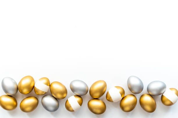 istock Silver and golden eggs isolated on white background. Easter decoration background. Top view 1313445001