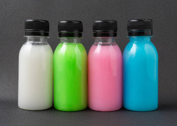 istock Colorful liquid in a bottles on black background. 1313445489