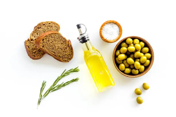 Photo of Sliced bread ciabatta with olives and oil. Greek or Italian meal
