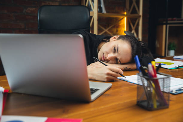 istock Young woman working in modern office using devices and gadgets. Making reports, analitycs, routine processing tasks 1313448221