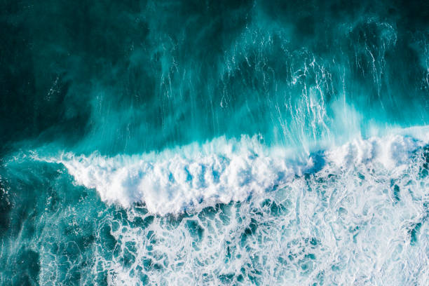 istock Big ocean waves hitting a coral reef. View from above. 1313448254