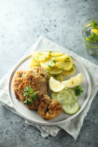 istock Schnitzel with potato salad 1313448284
