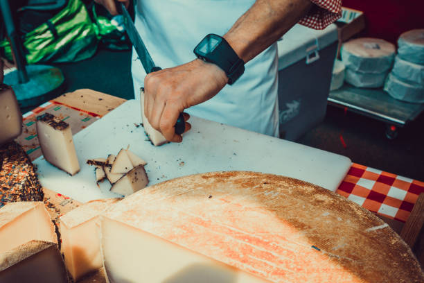 istock Worker slicing the cheese. Close up of Cutting cheese. 1313448600