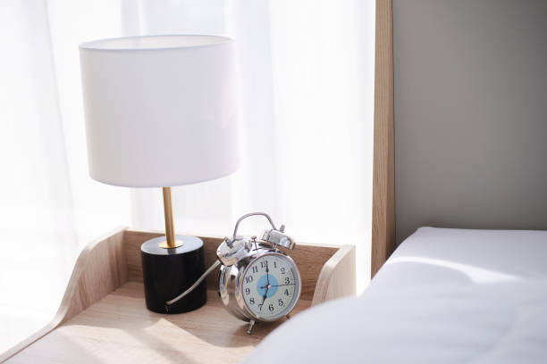 istock alarm clock on table near the bed 1313451847