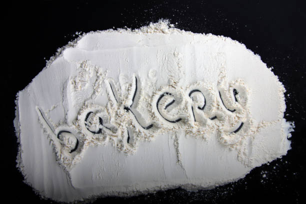 istock inscription Bakery made on flour against black background 1313451858