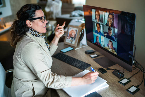 istock Female teacher teaching schoolchildren from home 1313452000