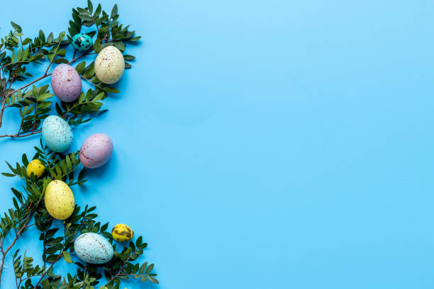 istock Frame of Easter eggs with spring branches and green leaves. Veiw from above 1313453642