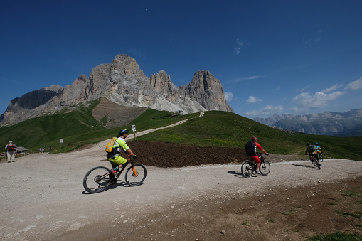 biker on high mountain road, Italian Dolomites, Trentino Alto Adige Italy