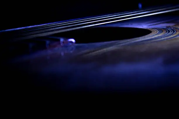 Closeup image of an acoustic guitar during the dark.The image is more dramatic,wich can goes everything that concerns dramatic acoustic music.
The photograph was shot at night in a dark room,with a white fluorenscent lightning coming from the left wich gives the image more definition and makes it alive.