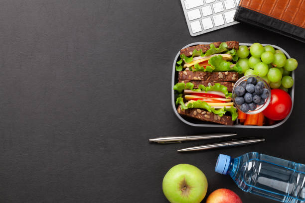 istock Healthy office lunch box with sandwich and fresh vegetables 1313454599
