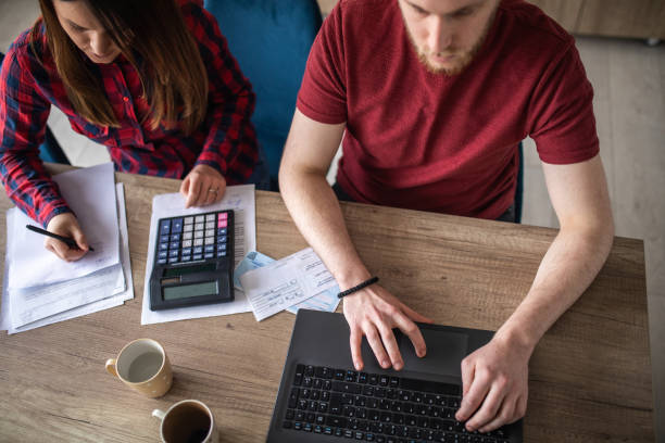 istock Young couple calculating their home finances together 1313458395