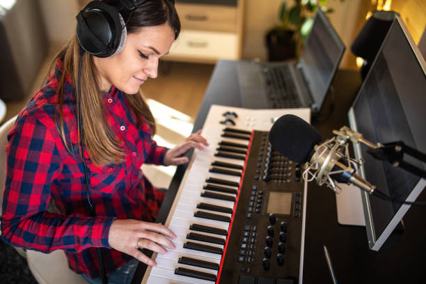 istock Young woman playing synthesizer at home 1313458529