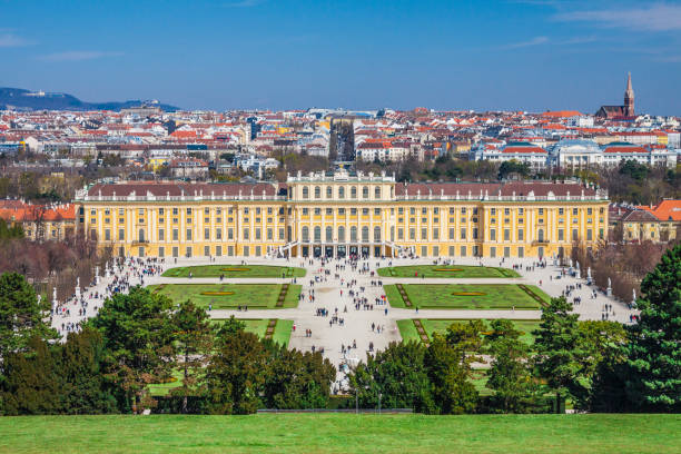 Austria - Vienna - The beautiful baroque palace Schonbrunn and its gardens and lawns with panorama of Vienna city on background