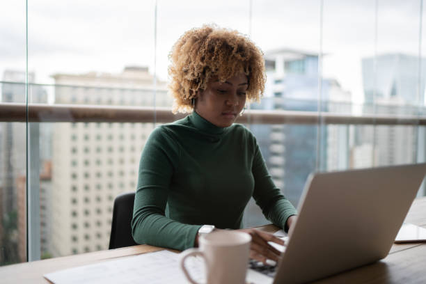 istock Young woman using laptop working at home 1313460340