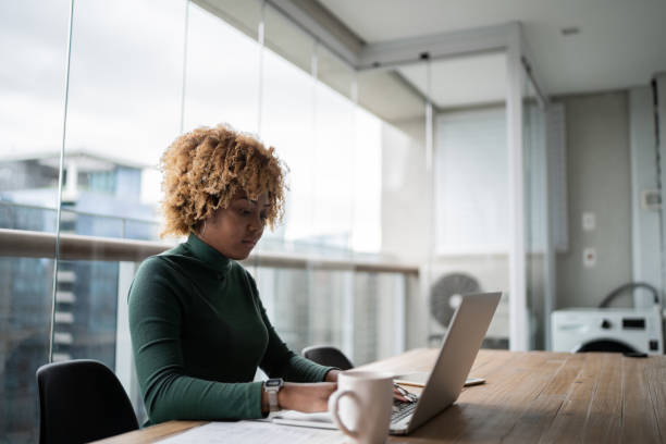 istock Young woman using laptop working at home 1313460352