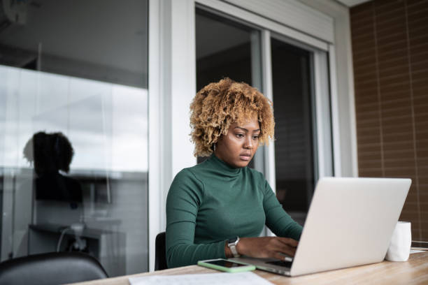 istock Young woman using laptop working at home 1313460378
