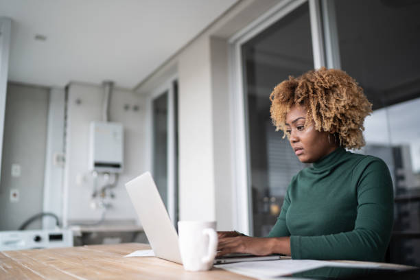 istock Young woman using laptop working at home 1313460406