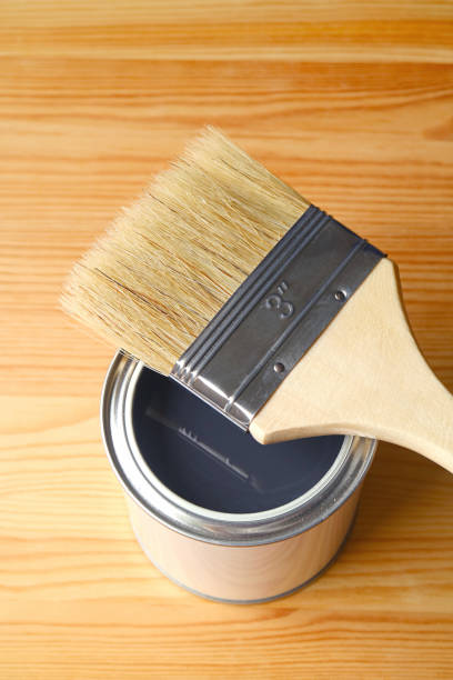 istock Paint brush on opened paint can isolated on wood plank 1313460777